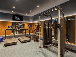 a gym with several treadmills and cardio equipment at TRIBE Krakow Old Town in Krakow