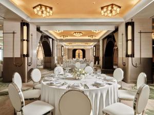 a ballroom with a table and chairs in a room at Swissotel Tashkent in Tashkent