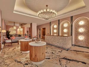 a lobby of a hotel with a chandelier at Fairmont Udaipur Palace in Udaipur