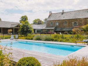 an image of a swimming pool in front of a house at Hotel de L'Abbaye Le Tronchet - Handwritten Collection in Le Tronchet