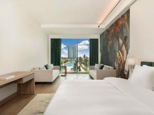 a hotel room with a bed and a desk at Rixos Obhur Jeddah Resort & Villas - All-Inclusive in Jeddah