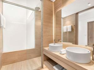 a bathroom with a white sink and a mirror at Rixos Obhur Jeddah Resort & Villas - All-Inclusive in Jeddah +76 photos