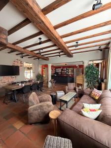 a living room with couches and a dining room at Comme à la Ferme in Durbuy