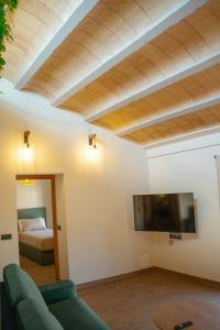 a living room with a couch and a flat screen tv at Casa 'El Tio Pedro' in Alcañiz