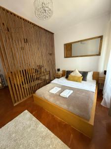 a bedroom with a bed with two towels on it at Baritiu Apartment Brasov in Braşov