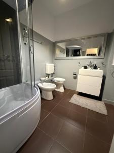 a bathroom with a tub and a toilet and a sink at Baritiu Apartment Brasov in Braşov +41 photos