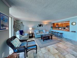 a living room with a couch and chairs and a table at Sabine Yacht & Racquet #5F in Pensacola Beach