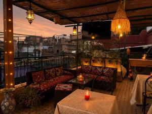 a balcony with couches and a table with candles at Dar Laabi - Riad Aya in Fez