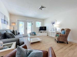 a living room with a couch and a tv at Blue Wave Villa East in Anna Maria