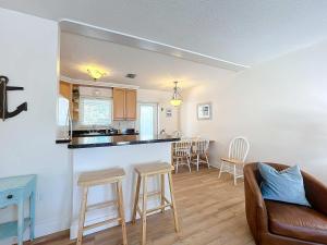 a living room with a couch and a kitchen at Blue Wave Villa East in Anna Maria