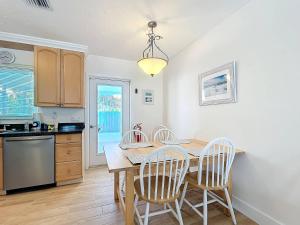 a kitchen with a dining room table and chairs at Blue Wave Villa East in Anna Maria