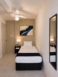 a bedroom with a large bed and a mirror at Casa Balam Cayo Lobo in Cancún +36 photos