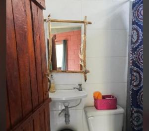 a bathroom with a sink and a toilet and a mirror at CO Casa Ocean in Juan de Acosta +38 photos