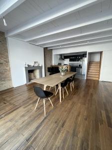 a large room with a wooden table and chairs at Saint Blaise in Les Herbiers