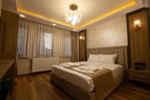 a bedroom with a bed and a chandelier at HOPEFULL HOTEL in Istanbul +127 photos