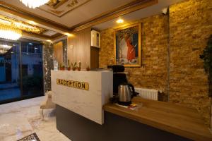 a reception desk in a room with a brick wall at HOPEFULL HOTEL in Istanbul