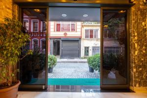 an open door to a courtyard with potted plants at HOPEFULL HOTEL in Istanbul