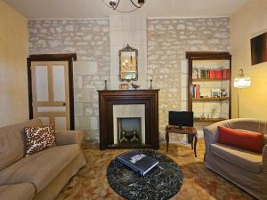 a living room with a couch and a fireplace at Aux grilles du Château de Saint-Aignan, à 2km de Beauval, les maisons de Sidonie et Léonard in Saint-Aignan