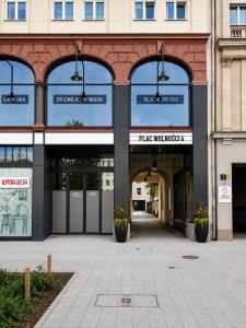 an entrance to a building with a parking garage at Apartamenty Wolności 6 self check-in in Poznań