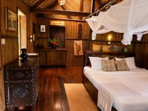 a bedroom with a bed and a dresser in a room at Analatsara Eco Lodge in Ile aux Nattes +109 photos