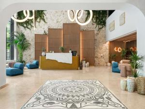 a lobby with a reception desk in a building at Mövenpick Hotel & Residences Teuta Kotor Bay in Kotor +182 photos