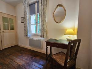 a room with a table and a mirror and a window at Aux grilles du Château de Saint-Aignan, à 2km de Beauval, les maisons de Sidonie et Léonard in Saint-Aignan +46 photos