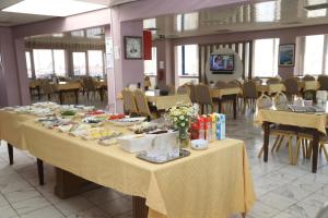 a long table with food on it in a restaurant at Alkış Otel in Iğdır +14 photos
