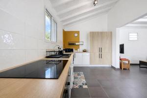 a kitchen with white walls and a counter top at Private Villa, Castel in Lamentin
