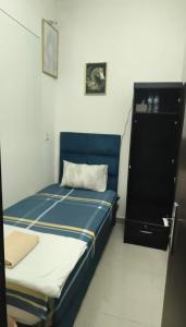 a small room with a bed and a dresser at Dream International City Homes in Dubai