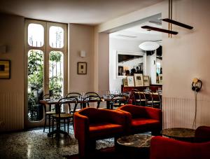 a restaurant with tables and chairs in a room at Le Pigalle, a Member of Design Hotels in Paris