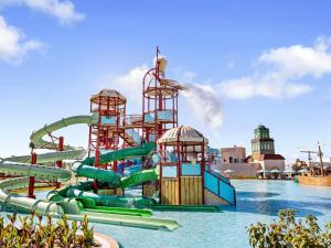 a water park with a water slide in the water at Rixos Murjana - Ultra All Inclusive in King Abdullah Economic City