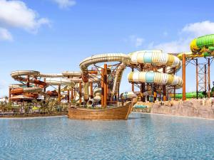 a large water park with a water slide at Rixos Murjana - Ultra All Inclusive in King Abdullah Economic City