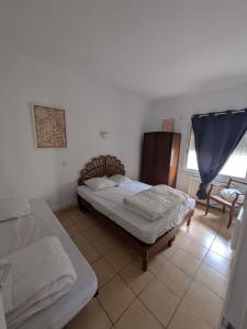 a bedroom with two beds in a room at Maison 5 chambres front de mer classée 3 étoiles tourisme in Narbonne