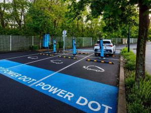 a car parked in a parking lot with a power dot at ibis Styles Clermont Ferrand Sud La Pardieu in Clermont-Ferrand