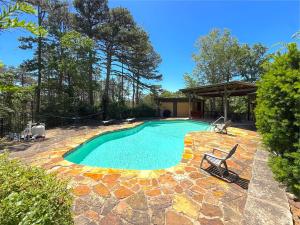 a swimming pool in a yard with a gazebo at Hidden Oasis Near Downtown in Eureka Springs