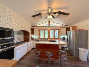 a kitchen with a ceiling fan and stainless steel appliances at Hidden Oasis Near Downtown in Eureka Springs