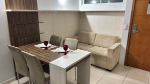 a dining room table with two wine glasses and a couch at Blue Sunset Experince - Cabo Branco in João Pessoa +12 photos