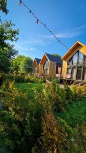 a large house in a yard with trees and grass at Luxury Cottage Resort in Patara-Tsemi