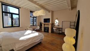 a bedroom with a bed and a table and chairs at Suite Stays Bruges - Pandreitje 6 in Bruges