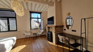 a bedroom with a bed and a fireplace and a mirror at Suite Stays Bruges - Pandreitje 6 in Bruges