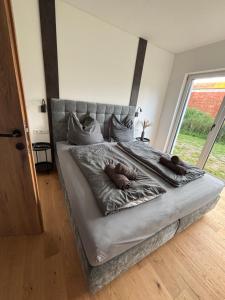a large bed with two stuffed animals on it at Alpenoase Ennstal in Ennsling