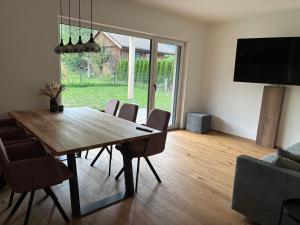 a dining room with a wooden table and chairs at Alpenoase Ennstal in Ennsling