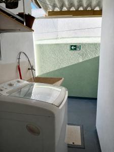 a small bathroom with a toilet and a sink at KaDinizHouse in Caraguatatuba +39 photos