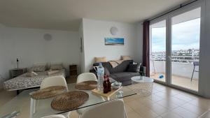 a living room with a couch and a table at Green Park ApartHotel Tenerife in San Miguel de Abona