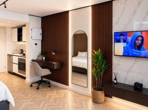 a bedroom with a bed and a sink and a tv on a wall at City Centre Oasis in Cape Town