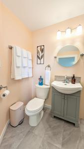 a bathroom with a toilet and a sink at Sunny Crest Burnaby-cozy one bedroom private suite in Burnaby