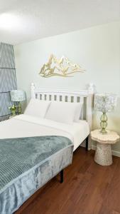 a bedroom with a white bed and a table at Sunny Crest Burnaby-cozy one bedroom private suite in Burnaby