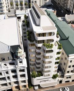 an overhead view of a white building with plants on it at City Centre Oasis in Cape Town
