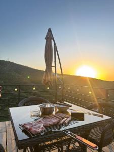 a table with two bowls of food on a balcony at SkyCamp Almaty in Almaty