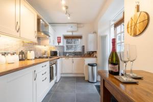 a kitchen with a bottle of wine on a counter at 1 Bed in Ambleside oc-lr036 in Ambleside +7 photos